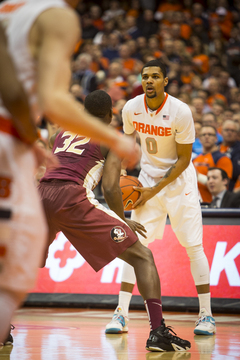 Gbinije surveys his options while being defended by FSU guard Montay Brandon.