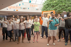 Participants in the sit-in at Schine Student Center on Wednesday raise their arms and identify themselves at the request of organizer Ronald Taylor. 