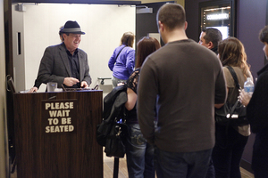 Al Canal, manager of Funny Bone comedy club, checks tickets as fans wait for a show to start.