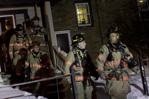 Syracuse firefighters file out of 320 Euclid Ave., where a small camp stove fire resulted in minor flooding Sunday night.