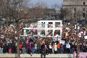 According to event organizers, an estimated 2,000 people came together for a protest against President Donald Trump in downtown Syracuse this morning on the lawn of the James M. Hanley Federal Building. 