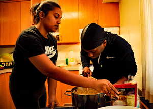 Hamwattie Heerman (left) and Judah Carter (right), two SU juniors, cook meals to be picked up by “For The Culture” customers.