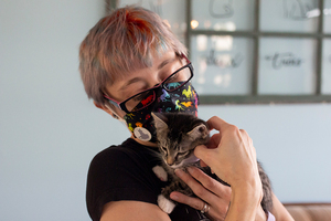 Alisha Reynolds holds Ollie, one of the five tiger kittens at Pawsitivitea CNY Cafe & Cat Lounge.