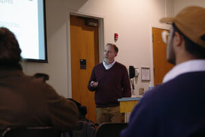 Dr. David “Sandy” Marshall speaks to a crowd of around 25 students in Syracuse University's Hall of Languages. His research entailed interviewing a multi-generational group of Palestinians to evaluate the oral traditions of religious sites.