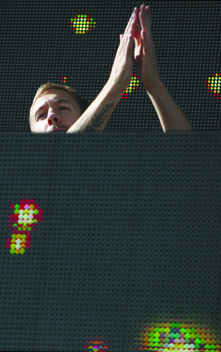 Calvin Harris claps his hands during his set.