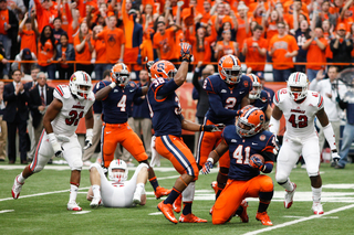 Lewellyn Coker (41) celebrates with teammates after recovering a muffed Louisville punt in the first half.