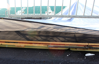 The court is seen as a tarp is lifted aboard the USS Midway Museum on Nov. 8, 2012, before the Battle on the Midway game between the Syracuse Orange and the San Diego State Aztecs scheduled for Sunday.