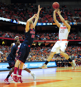 Syracuse guard Brandon Triche takes a jump shot over Detroit's Evan Bruinsma.