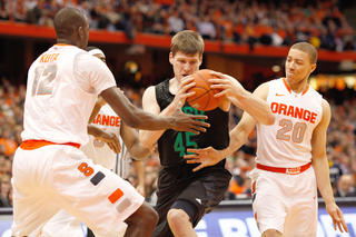 Baye Moussa Keita and Brandon Triche hold up Notre Dame's Jack Cooley. The Fighting Irish star forward was limited to a relatively tame 10 points and 11 rebounds.