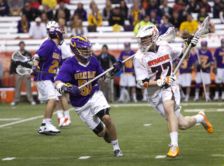 JoJo Marasco cradles the ball, running at Anthony Ostrander. Marasco finished with three goals and five assists, the most points for an SU player since Kenny Nims recorded eight against Providence Feb. 15, 2009.