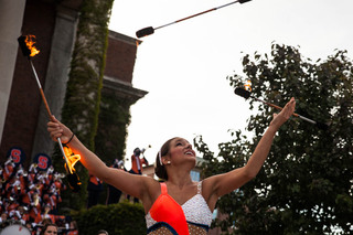 The SU Orange Girl juggles fire prior to Syracuse's home-opening game. 