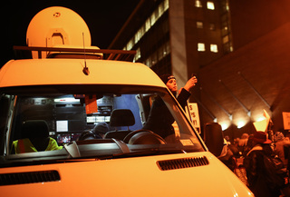 Sarah Blaznois, a Time Warner Cable videojournalist, uses her phone to record protesters near the Patrick J. Corbett Justice Center. 