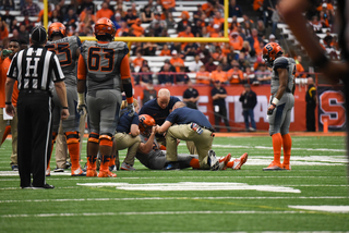 More players congregate around Dungey. When he returned to the game, he had a brace on his right knee. 