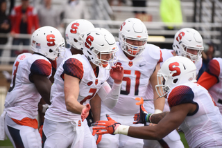 Dungey slaps hands with running back Dontae Strickland after a Syracuse touchdown.