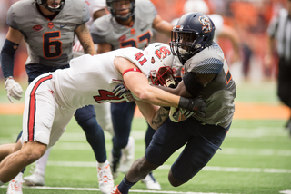 A North Carolina State player attempts to wrap up an SU player.