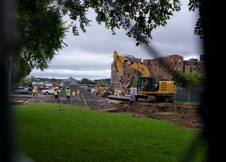 Construction crews watch as a section of pipe is laid into a trench along Waverly Avenue for the sewage line upgrade. Photo taken July 25, 2017