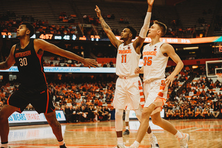 Players react as freshman forward Robert Braswell drills a corner 3.
